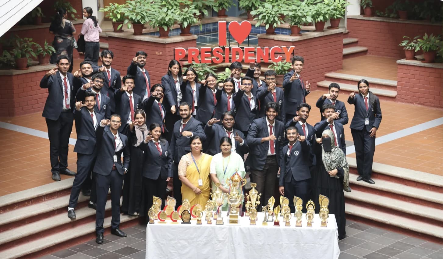 Graduates in suits on the campus steps