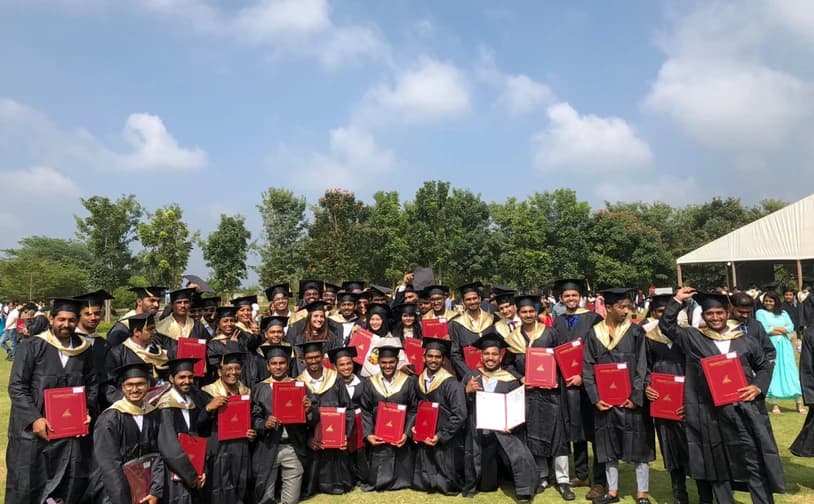 Graduating class holding their degree certificates