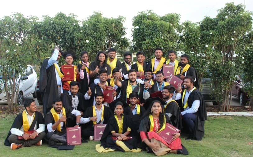 Graduates with certificates on the lawn