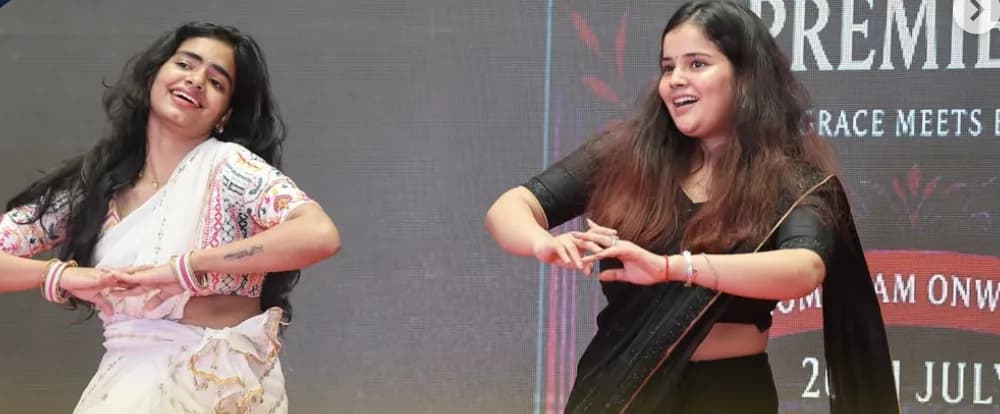 Two students performing a dance in traditional attire