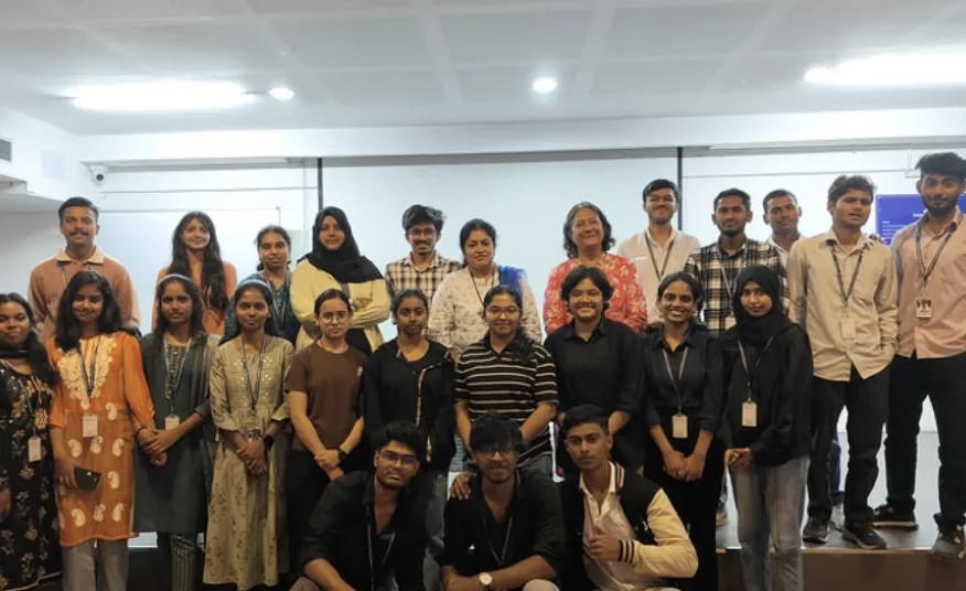 Students and faculty posing together on stage
