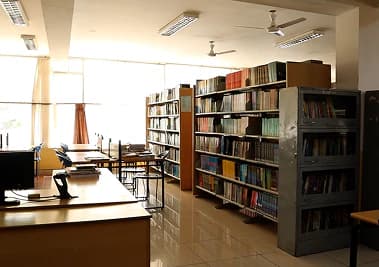 Library bookshelves beside the reading tables
