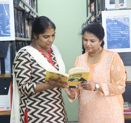 Library staff reviewing a book together